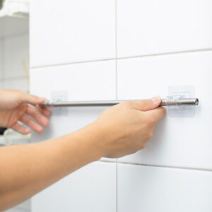 Itsekiinnittyvä verhotangonpidike