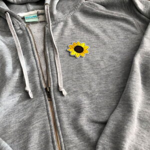 Tygmärke solros på grå tröja